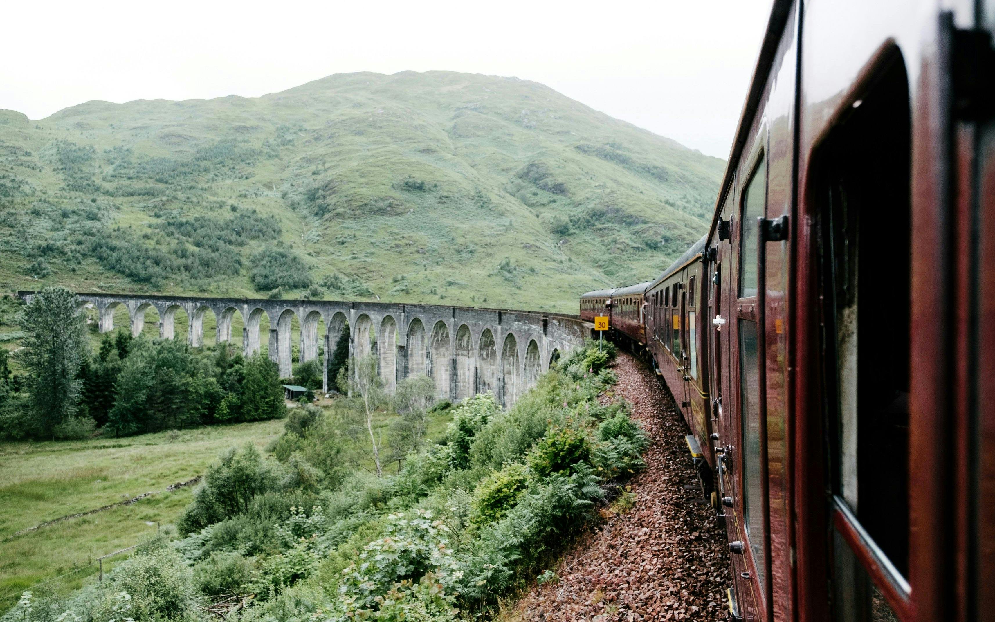 Steam train crossing the Glenfinnan Viaduct in Scotland.
