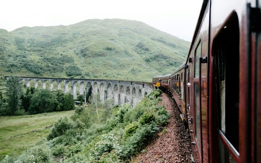 Steam train crossing the Glenfinnan Viaduct in Scotland.