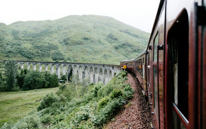 Steam train crossing the Glenfinnan Viaduct in Scotland.