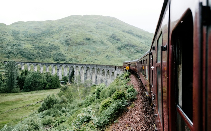 Steam train crossing the Glenfinnan Viaduct in Scotland.