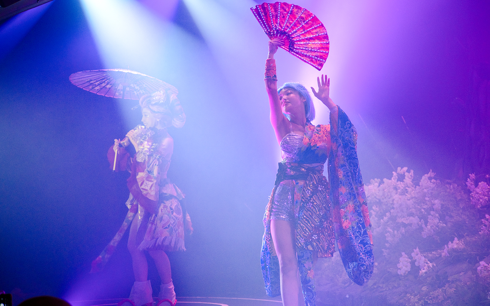 Performers in traditional attire with fans at Samurai Restaurant Show.