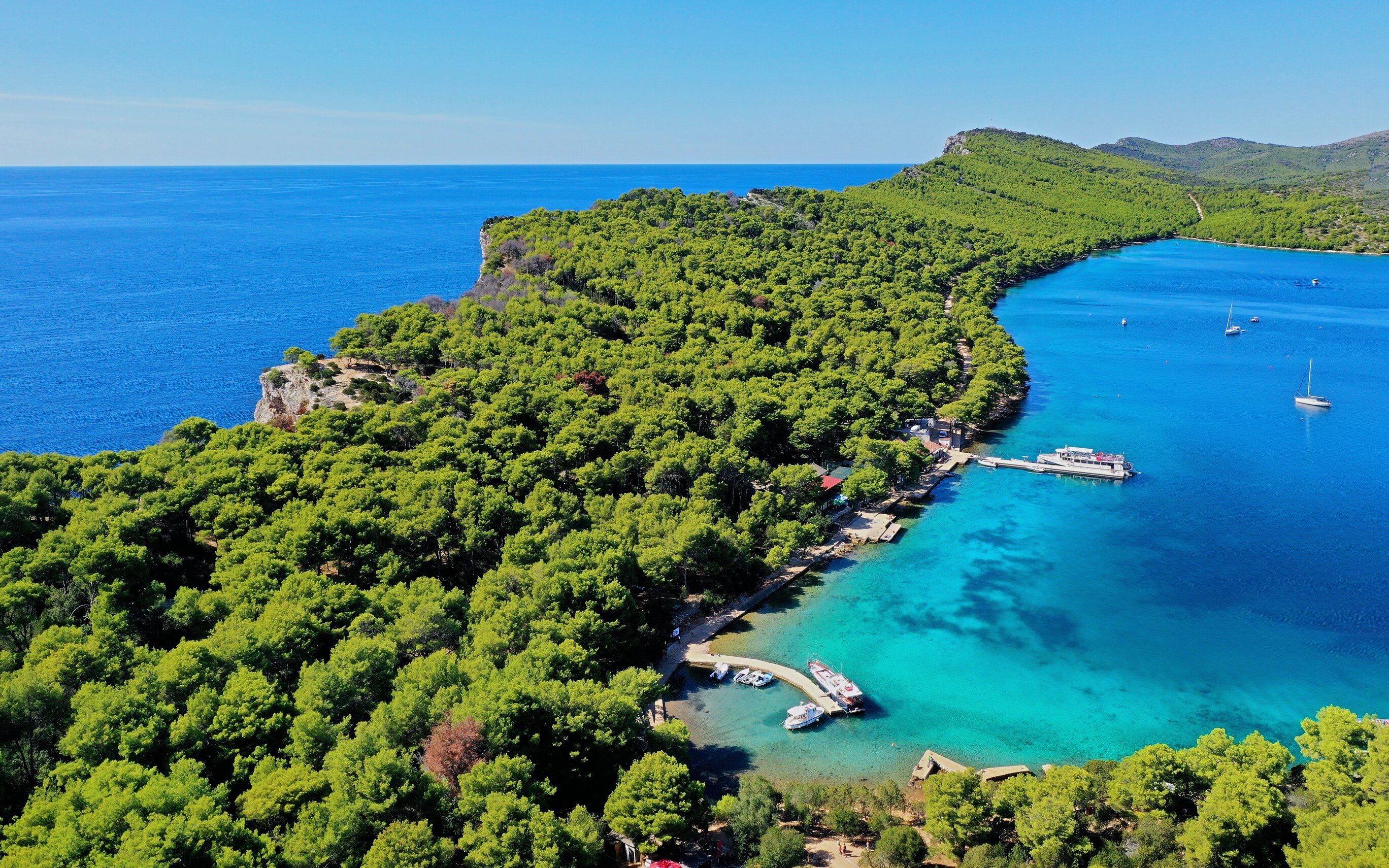 Aerial view of Telašćica Nature Park's coastline and boats in Croatia.