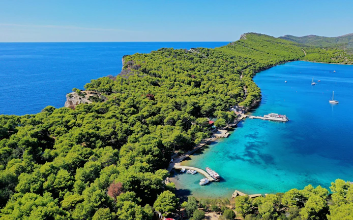 Aerial view of Telašćica Nature Park's coastline and boats in Croatia.