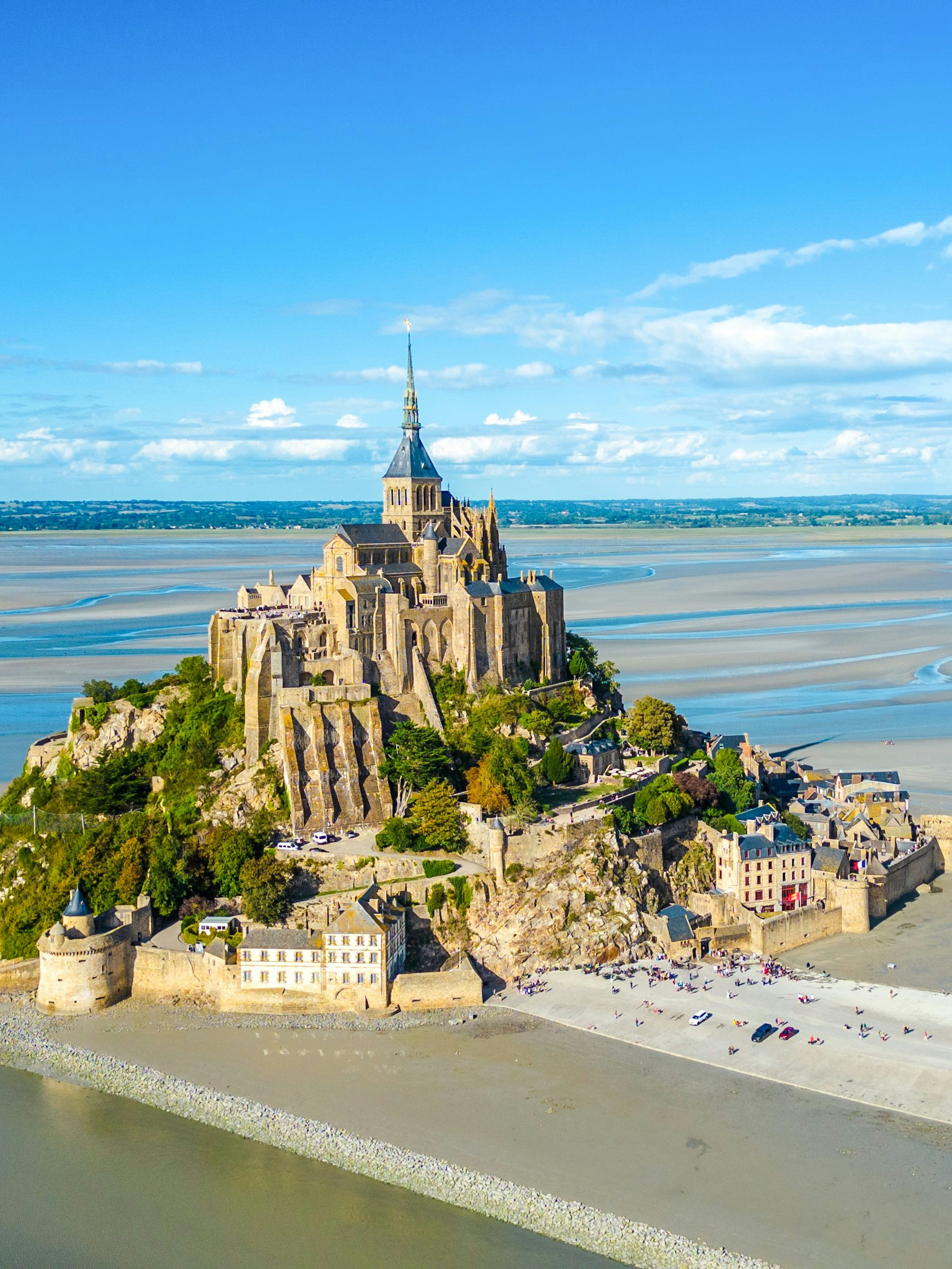Mont-Saint-Michel with Abbey surrounded by tidal waters in Normandy, France.