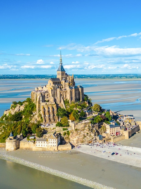 Mont-Saint-Michel with Abbey surrounded by tidal waters in Normandy, France.