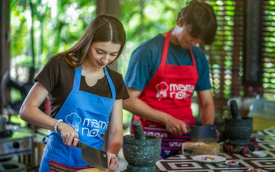 Tourists participating in a cooking class at Mamanoi Cookery School.