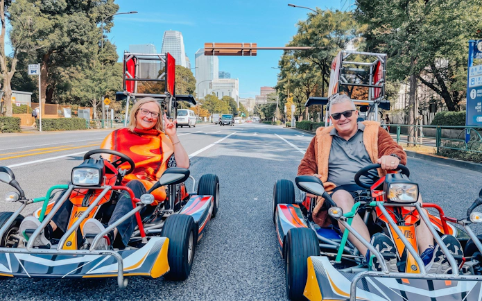 Go-karting on Shibuya streets with city skyline in background, part of NEO SHIBUYA EDGE experience.