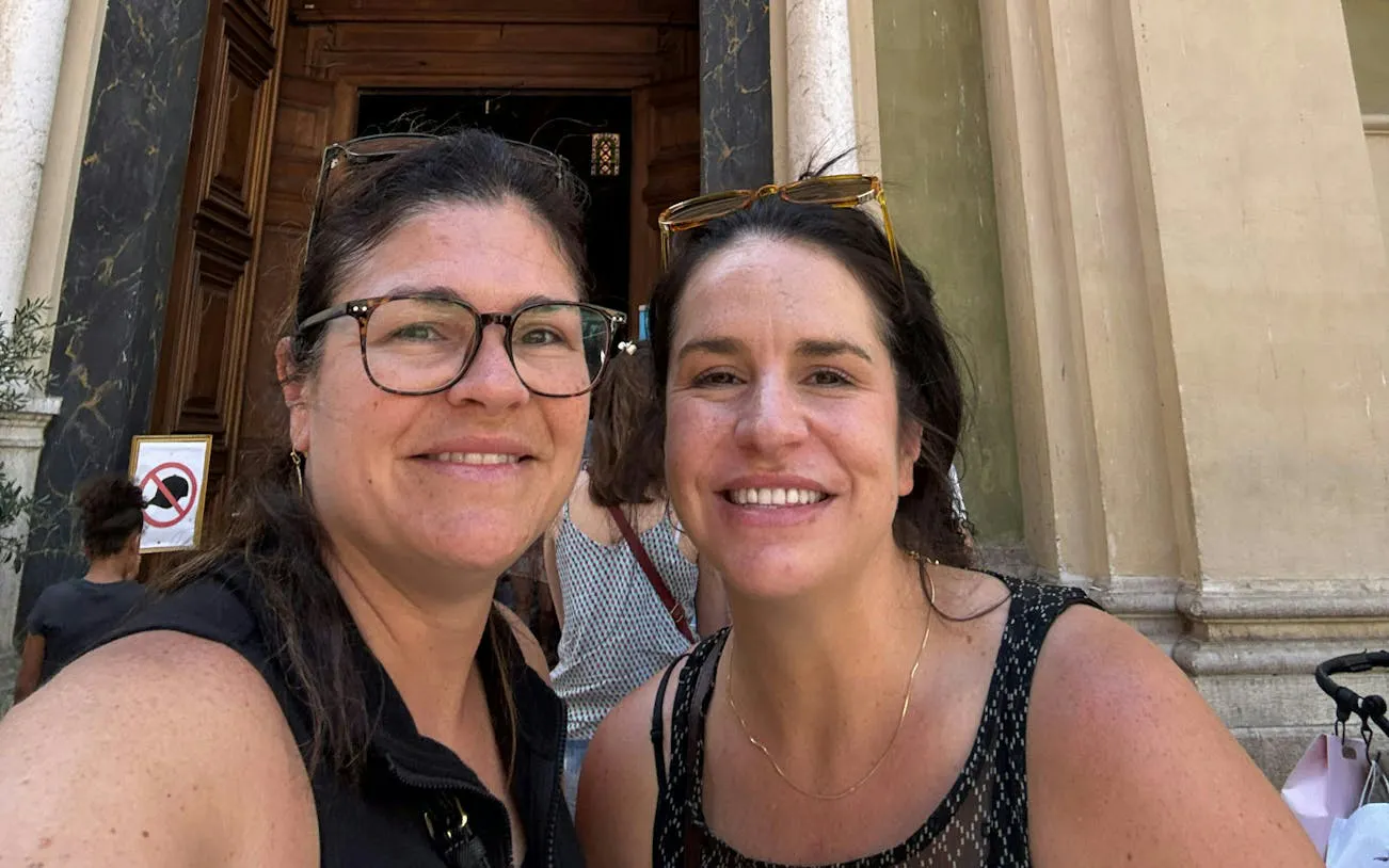 I don't know who these people are, but they are smiling in front of a historic building entrance in Nice.