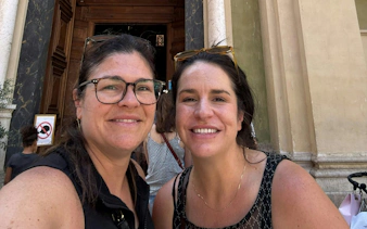 I don't know who these people are, but they are smiling in front of a historic building entrance in Nice.