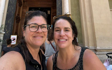 I don't know who these people are, but they are smiling in front of a historic building entrance in Nice.