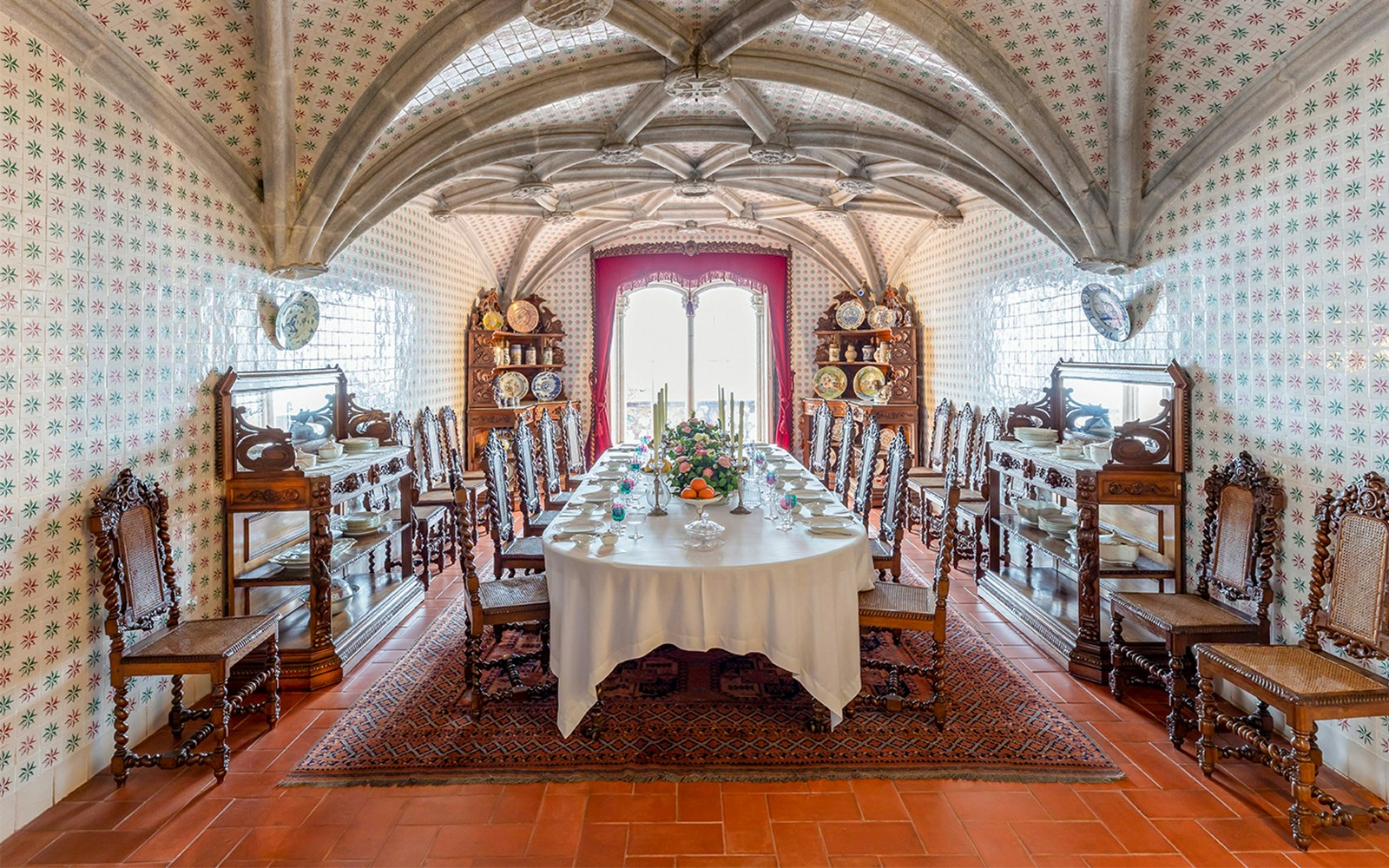 Pena Palace dining room and pantry with ornate furnishings and historical decor in Sintra, Portugal.