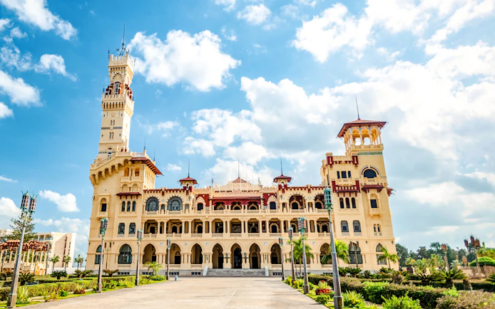 Royal Palace with Turkish and Florentine architecture, 1930s style, under a blue sky.