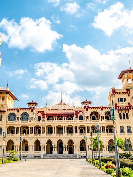 Royal Palace with Turkish and Florentine architecture, 1930s style, under a blue sky.