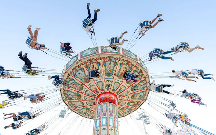 Riders on a colorful swing ride at the State Fair of Texas.