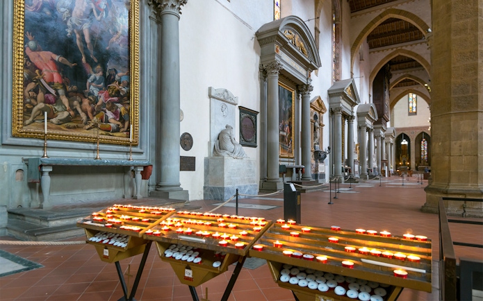 Candles and artwork inside Santa Croce Basilica, Florence.