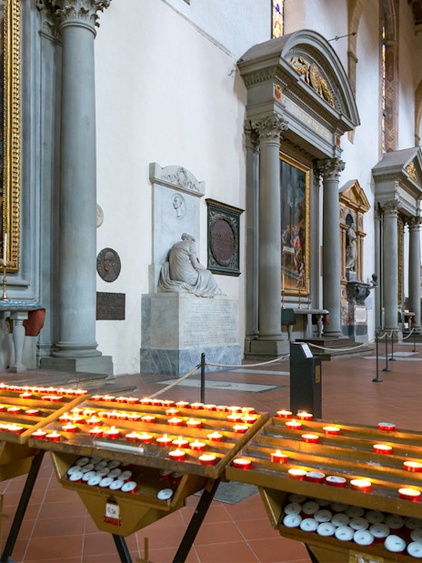 Candles and artwork inside Santa Croce Basilica, Florence.