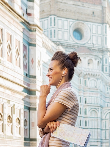 Woman using audio guide near Florence Cathedral.