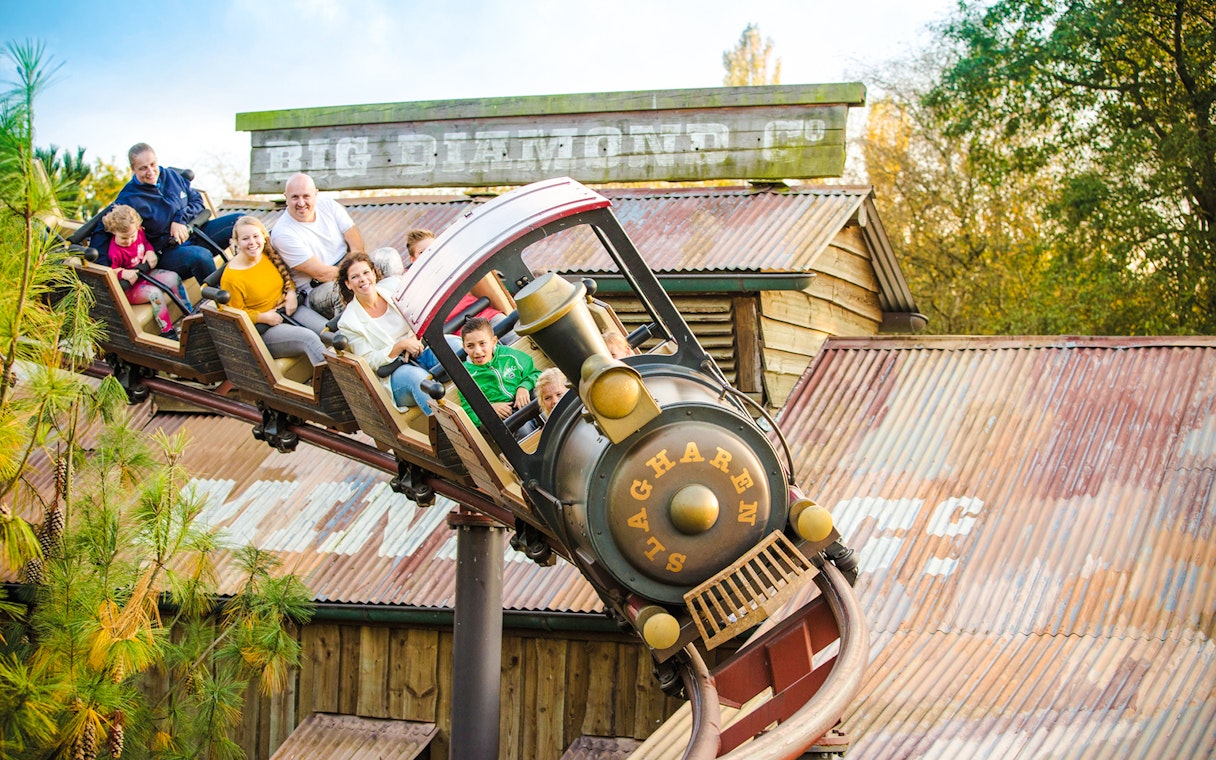 Pioneer Express roller coaster at Slagharen's Wild West with riders enjoying the thrill.