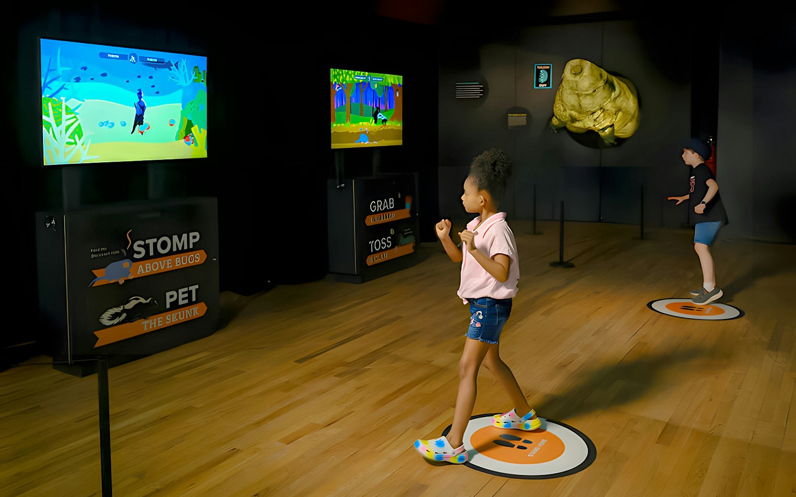 Children engaging with interactive displays at the 'Life at the Limits' exhibition, American Museum of Natural History.