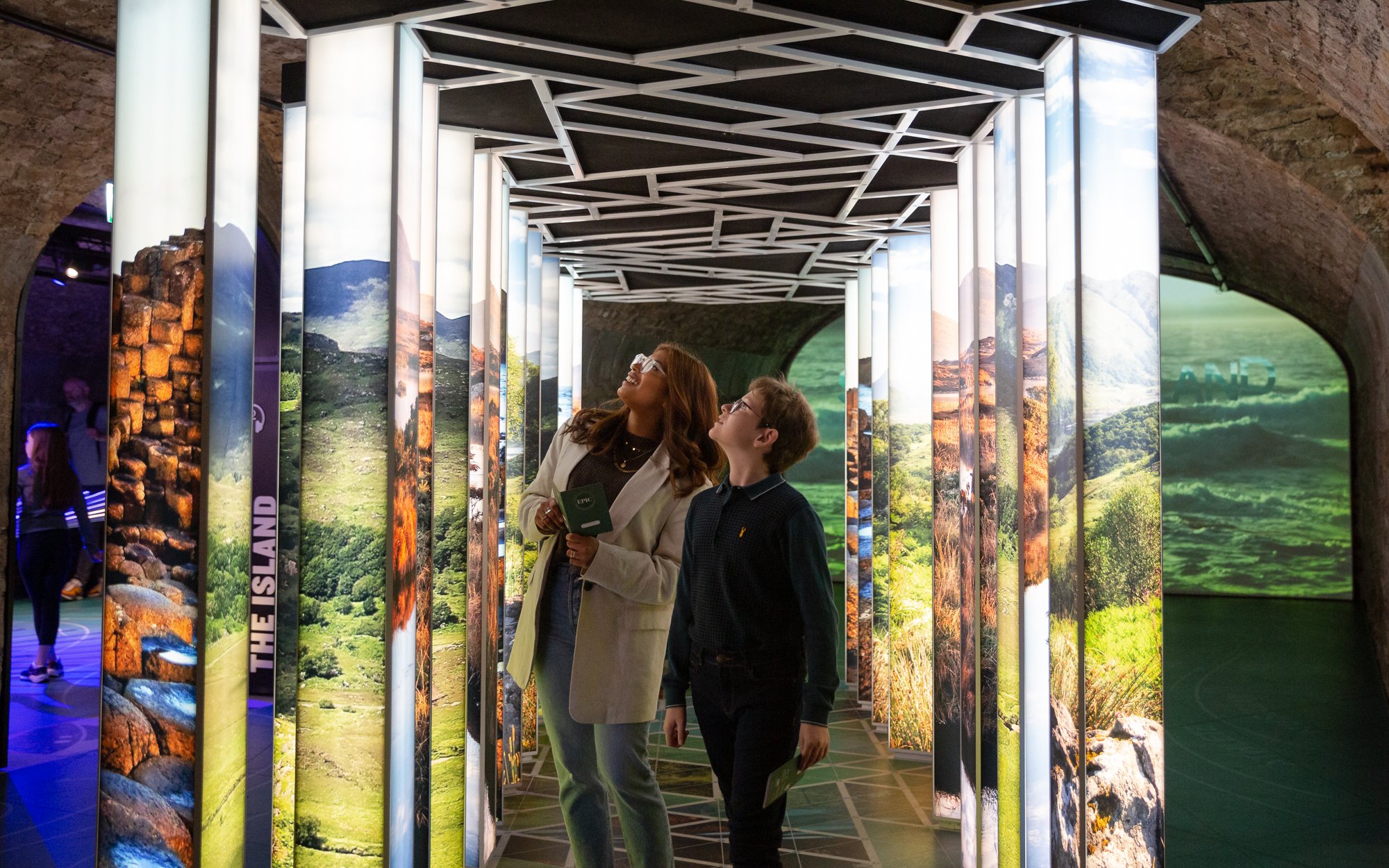 Visitors exploring illuminated displays at the Epic Museum.