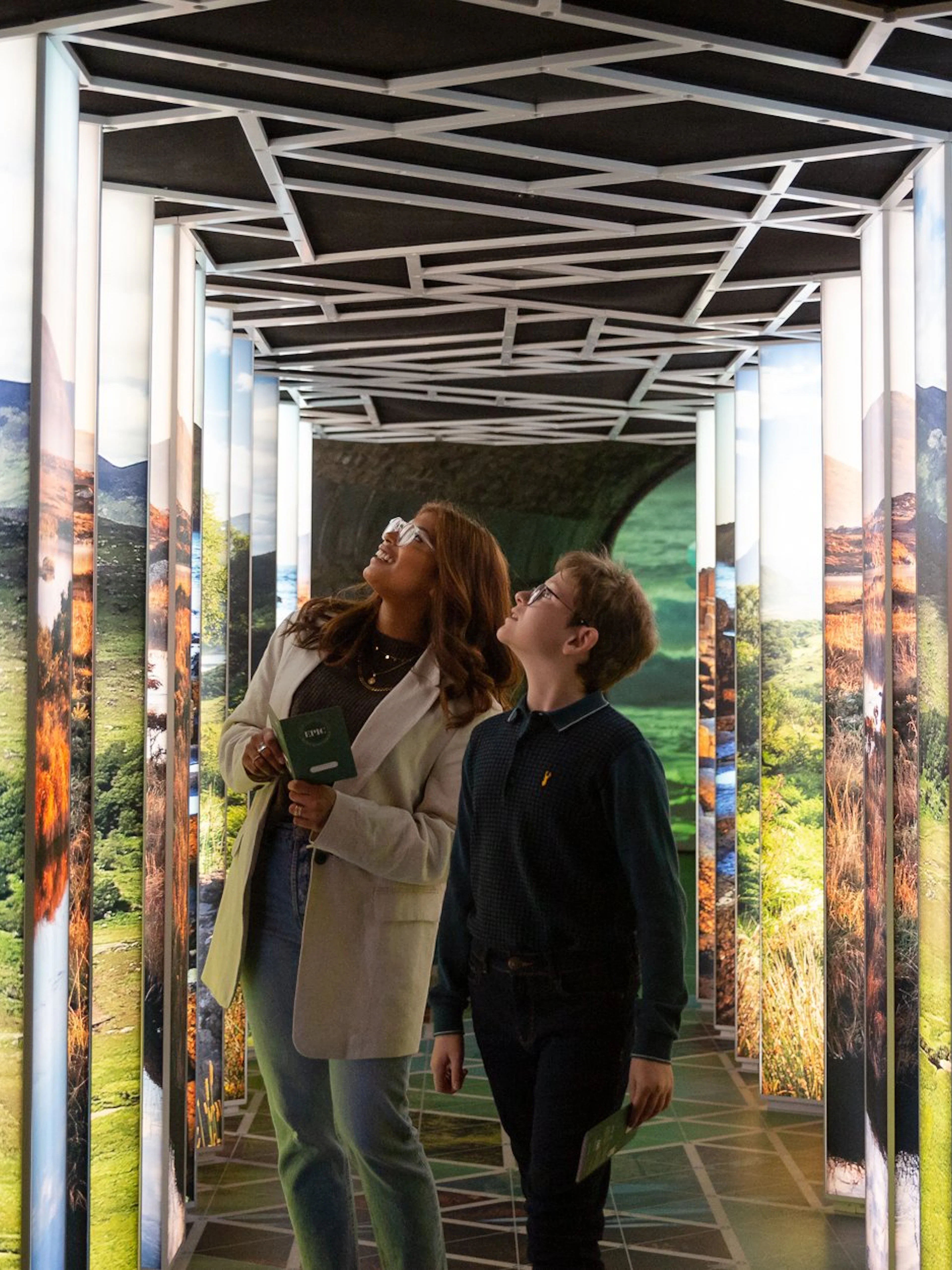 Visitors exploring illuminated displays at the Epic Museum.