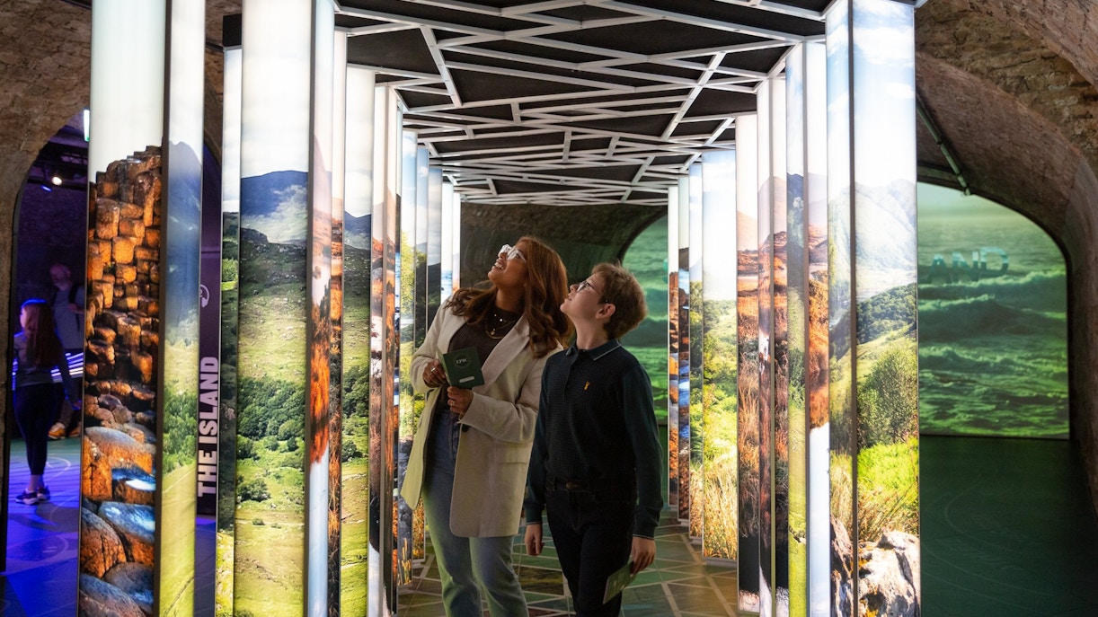 Visitors exploring illuminated displays at the Epic Museum.