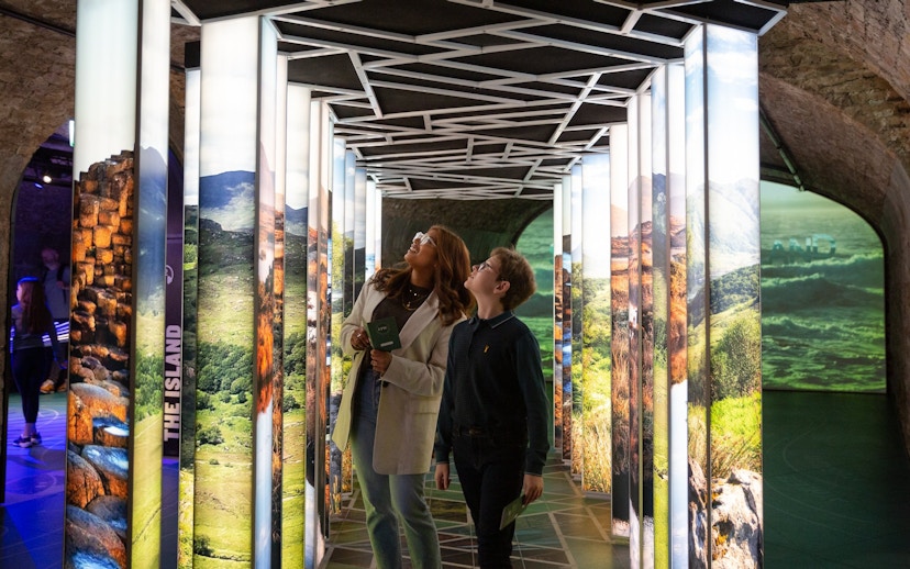 Visitors exploring illuminated displays at the Epic Museum.