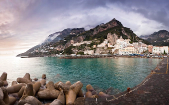Amalfi Coast view with colorful cliffside buildings and turquoise sea.