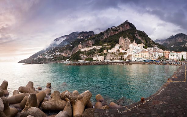 Amalfi Coast view with colorful cliffside buildings and turquoise sea.