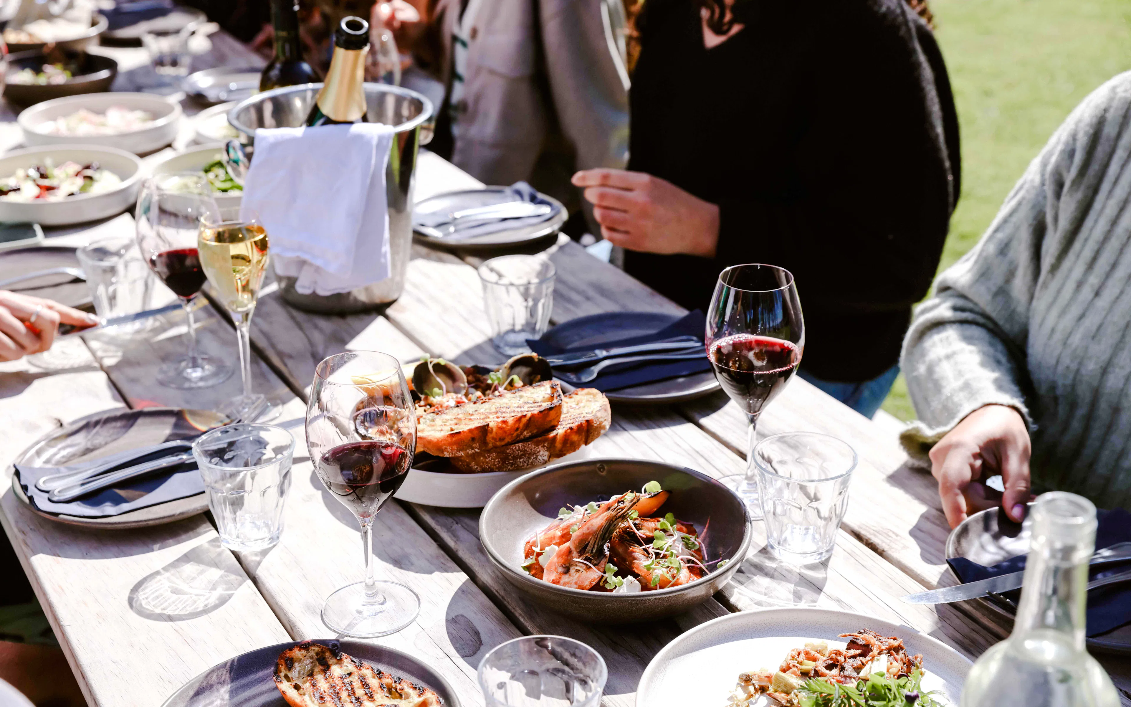 Dining setup with seafood and wine on Auckland cruise table.