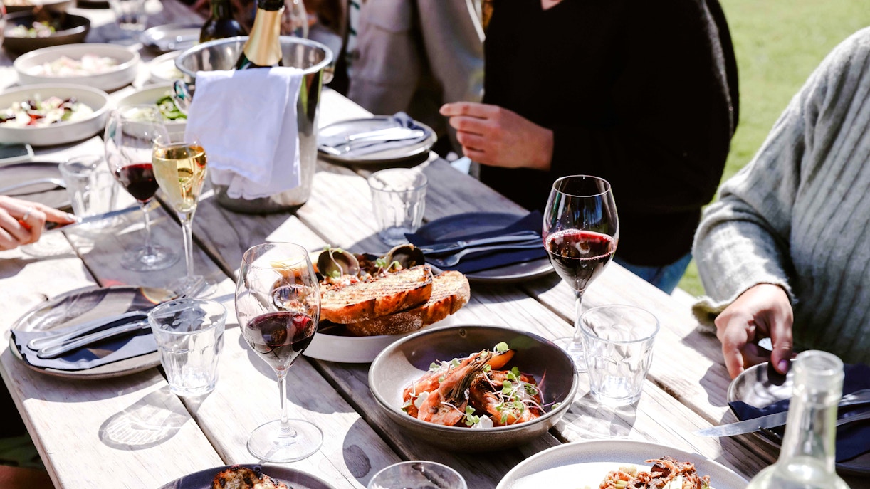 Dining setup with seafood and wine on Auckland cruise table.