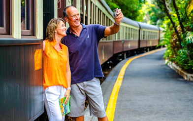 Couple taking a selfie by the Kuranda Scenic Railway train in Cairns.