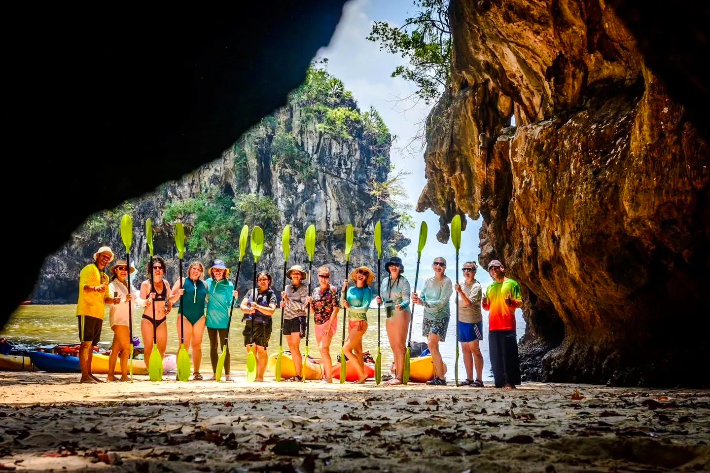 Group kayaking at Ao Thalane, Krabi, with limestone cliffs in the background.