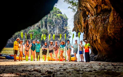 Group kayaking at Ao Thalane, Krabi, with limestone cliffs in the background.