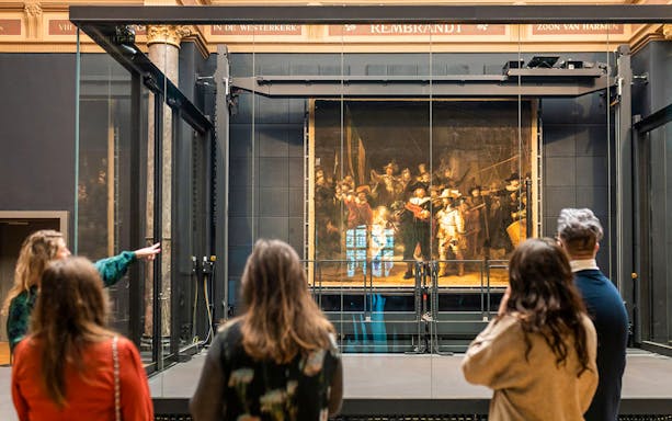 Visitors viewing Rembrandt's "The Night Watch" at the Rijksmuseum, Amsterdam.