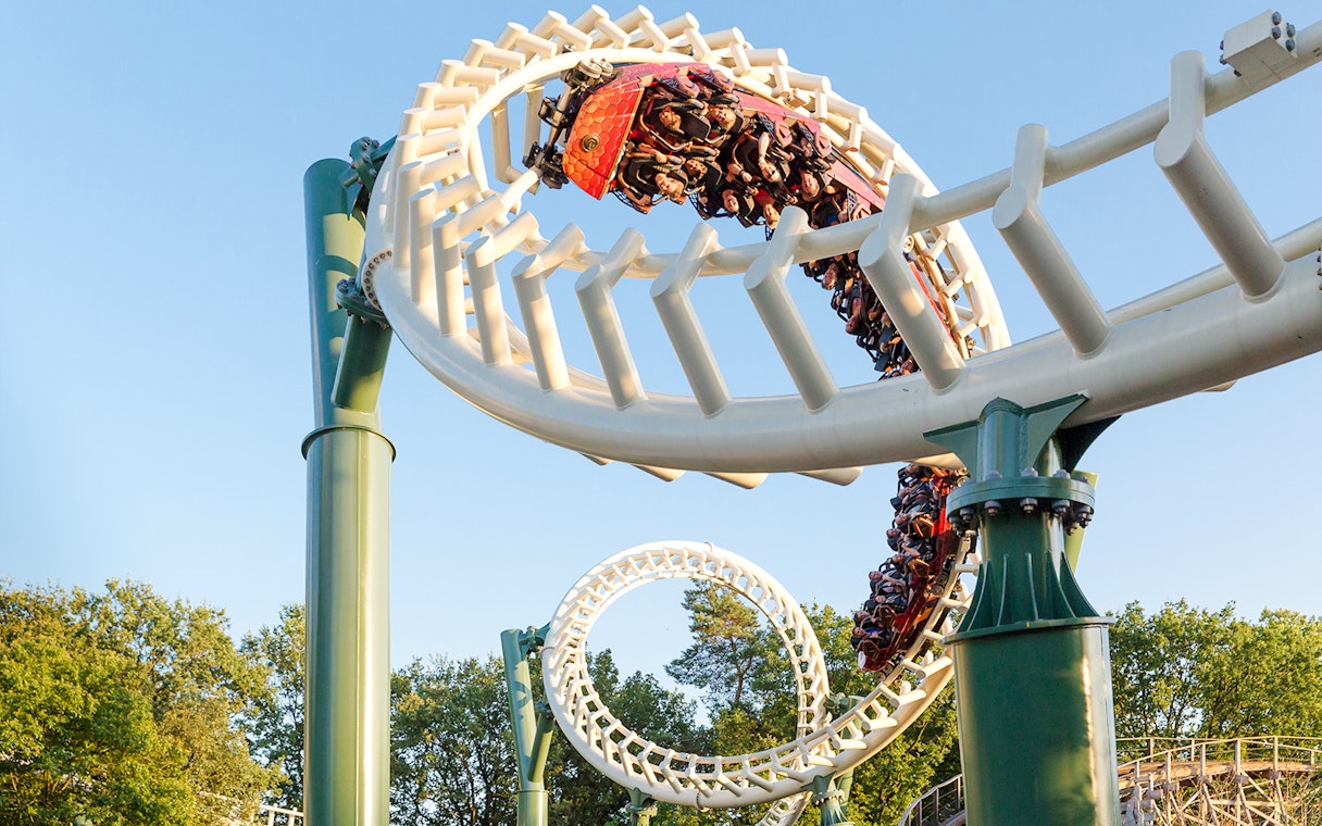 Guests riding a looping roller coaster at Efteling Theme Park.