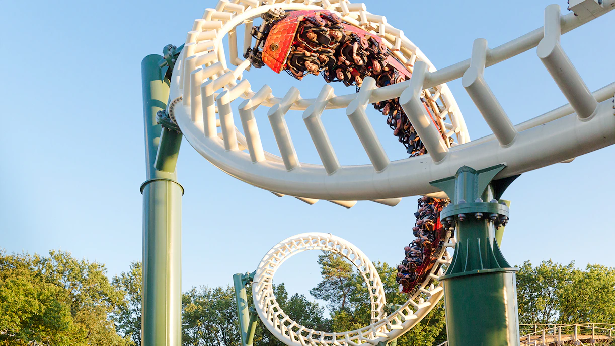 Guests riding a looping roller coaster at Efteling Theme Park.
