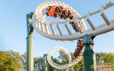 Guests riding a looping roller coaster at Efteling Theme Park.