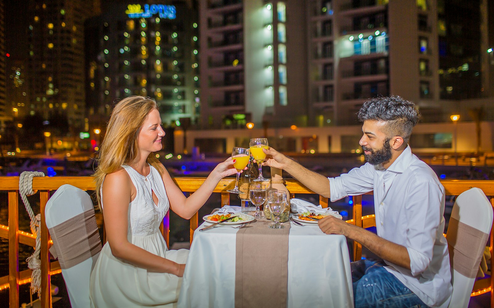 Couple dining on Alexandra VIP Dhow Cruise in Dubai Marina.