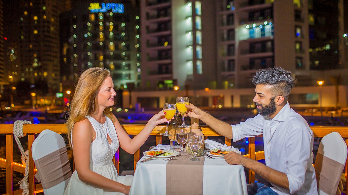 Couple dining on Alexandra VIP Dhow Cruise in Dubai Marina.