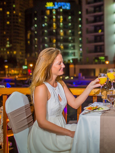 Couple dining on Alexandra VIP Dhow Cruise in Dubai Marina.