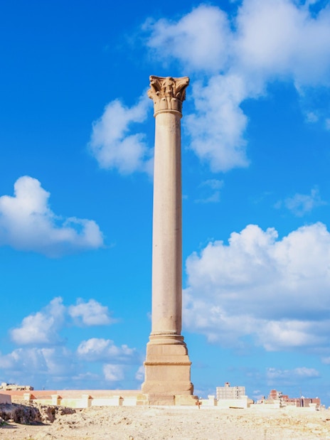 Pompey's Pillar with ancient sphinx statues in Alexandria, Egypt.