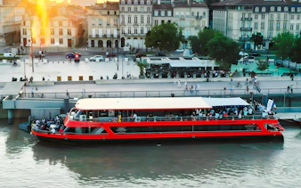 Bateaux Bordelais dinner cruise boat docked by the river in Bordeaux, France.