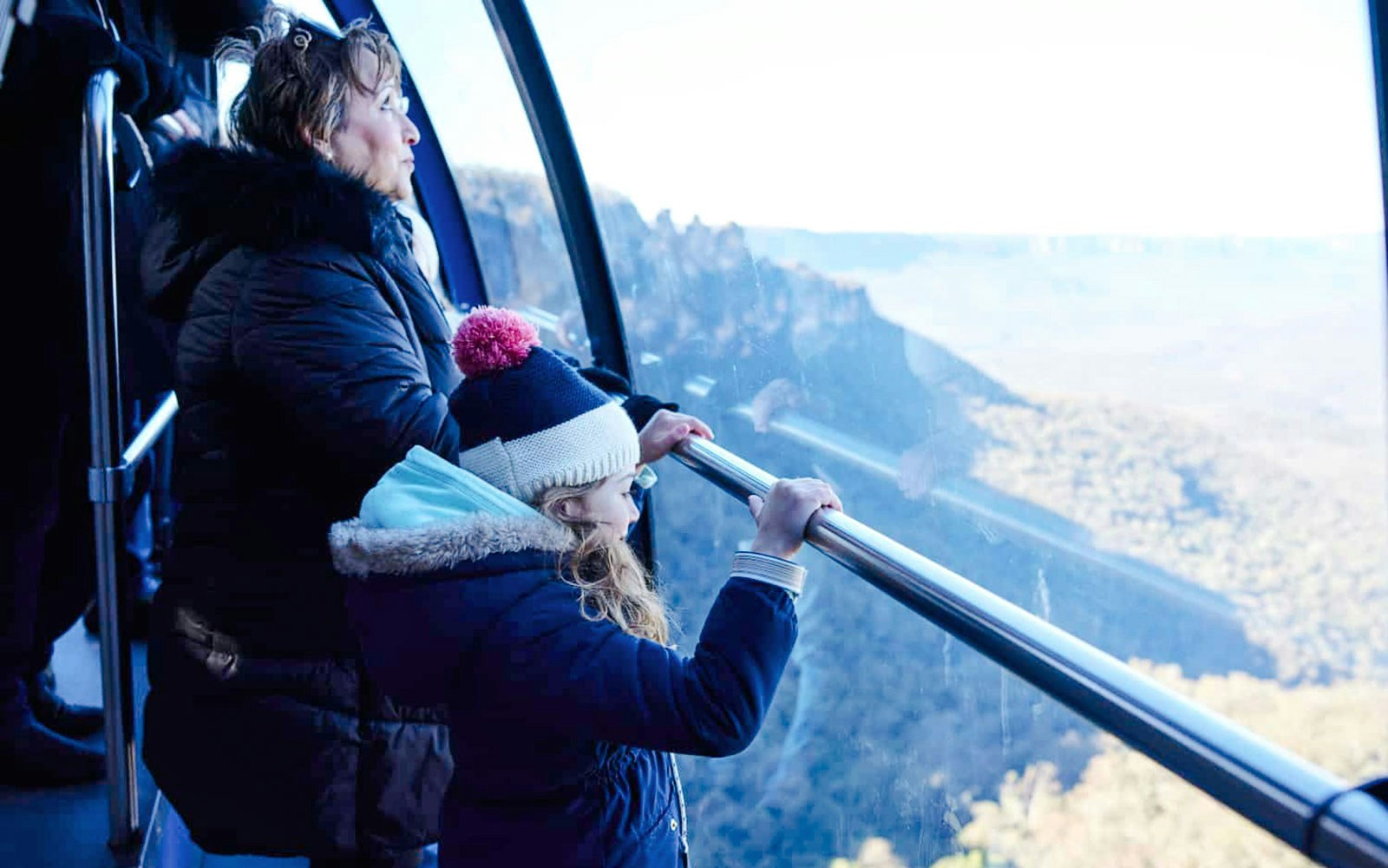 Child viewing landscape from skywalk cable car.