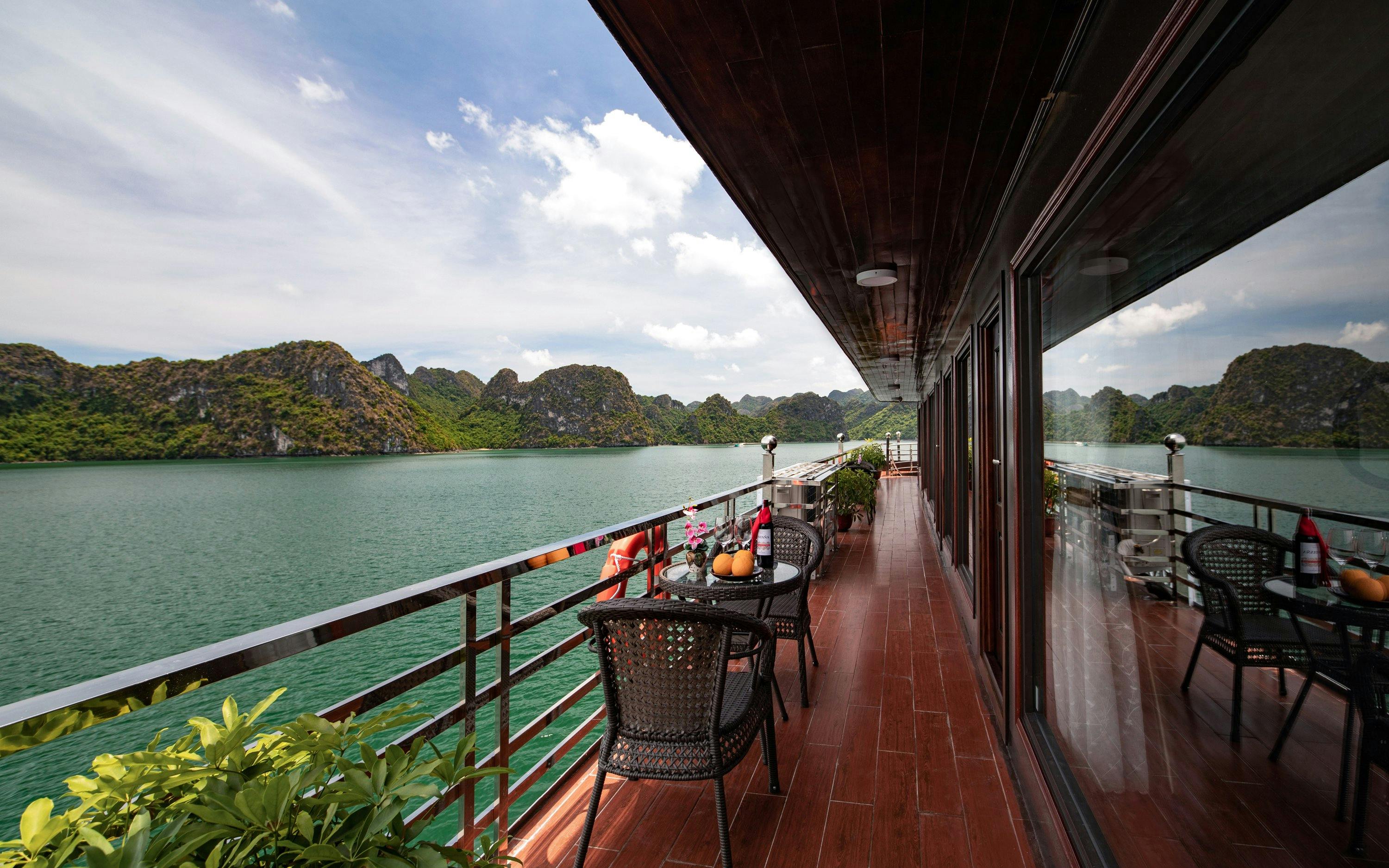 Cruise deck overlooking Lan Ha Bay with limestone karsts in the background.