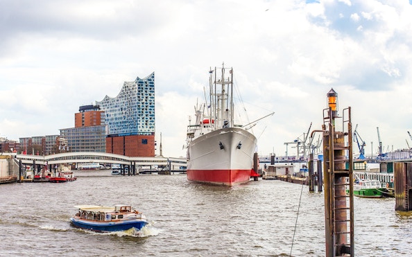 Boat passing Elbphilharmonie and ship in Hamburg Harbor during 2-hour boat tour.