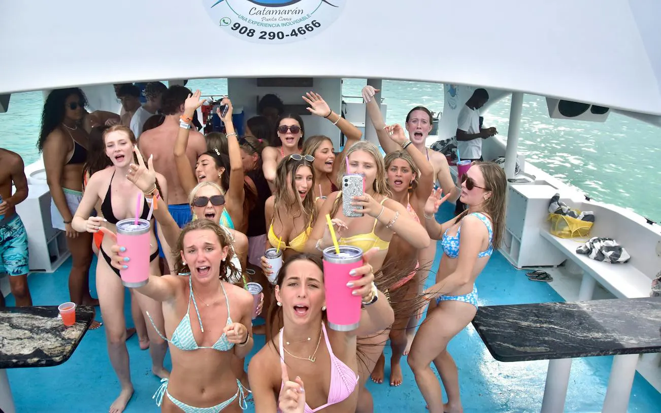 Adults enjoying a party boat cruise with drinks and music in Punta Cana.