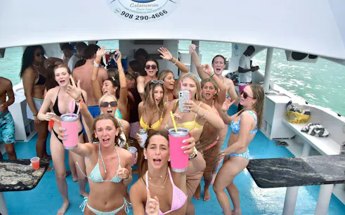 Adults enjoying a party boat cruise with drinks and music in Punta Cana.