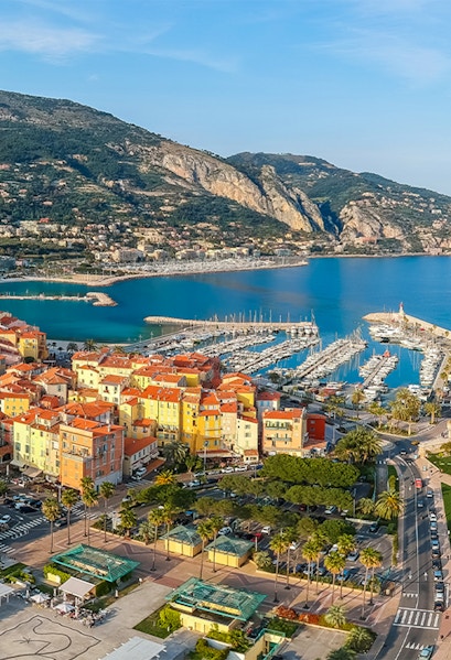 Aerial view of colorful buildings and marina in Menton, French Riviera.