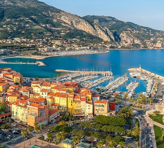 Aerial view of colorful buildings and marina in Menton, French Riviera.